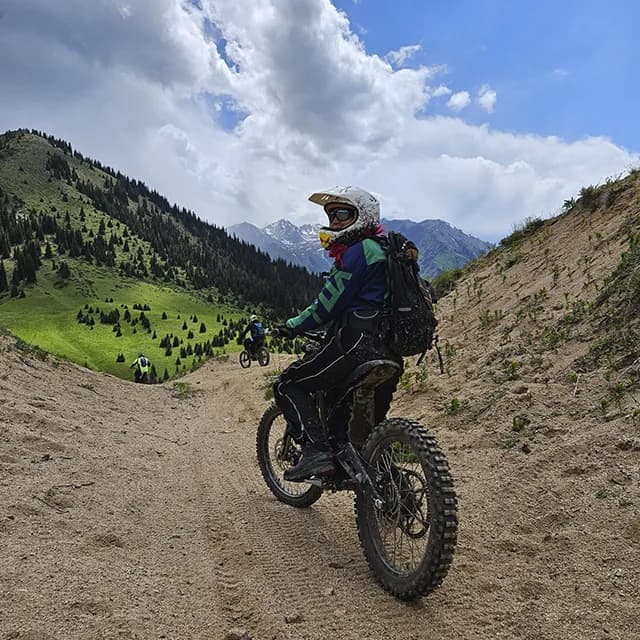 Природный скальный балкон над глубокой зелёной горной долиной